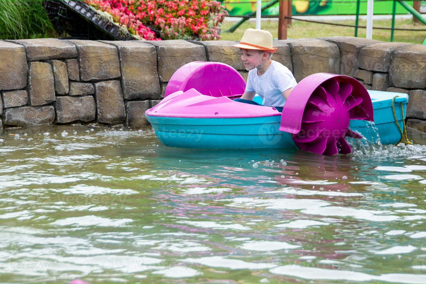 Kid playing rowing water paddle boat. Soft focus. . High quality photo