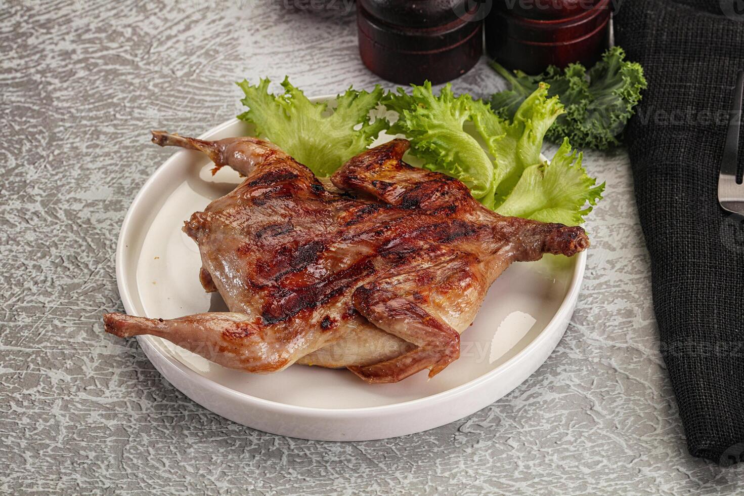 Grilled quail in the plate photo