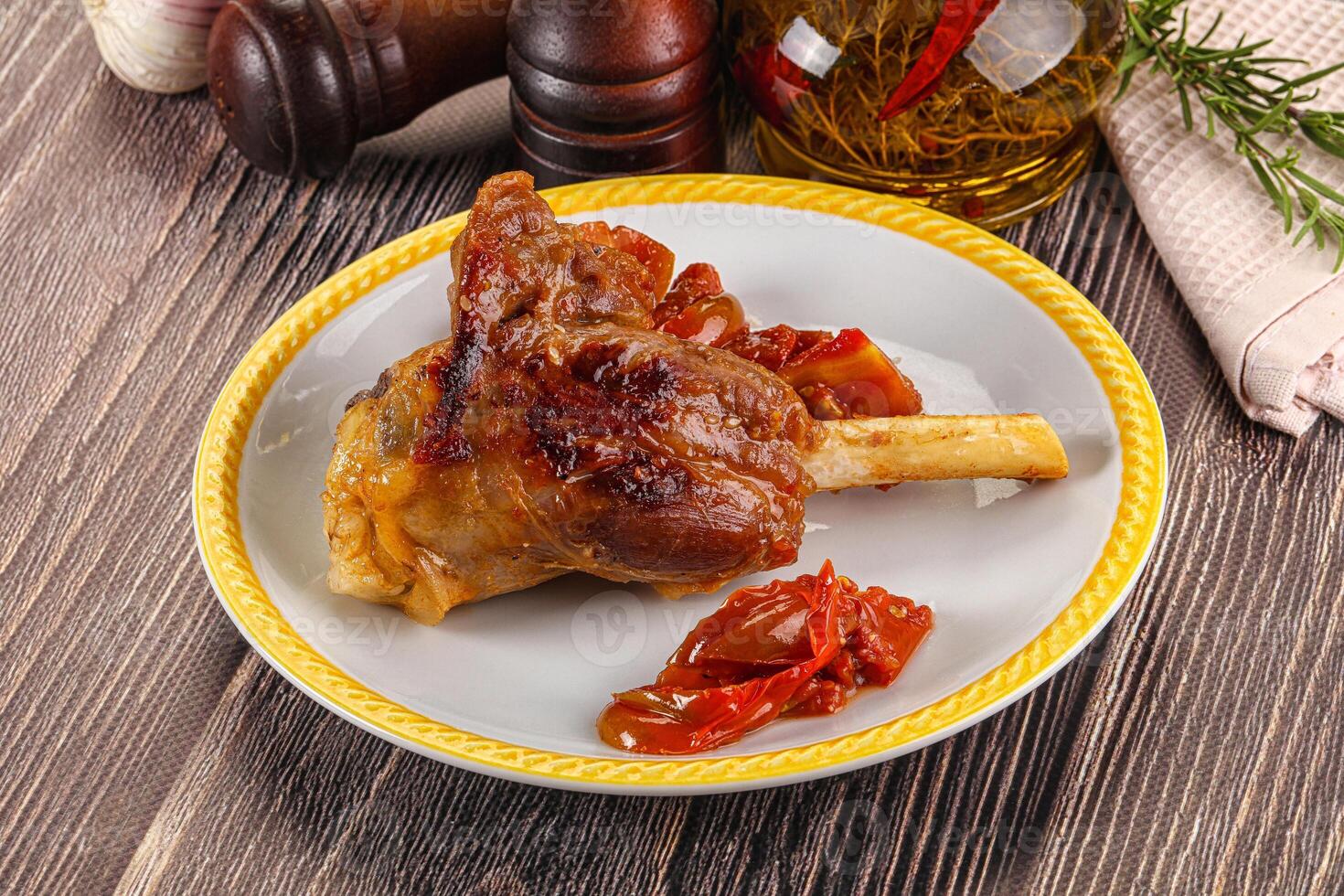 Baked lamb shank with vegetables photo
