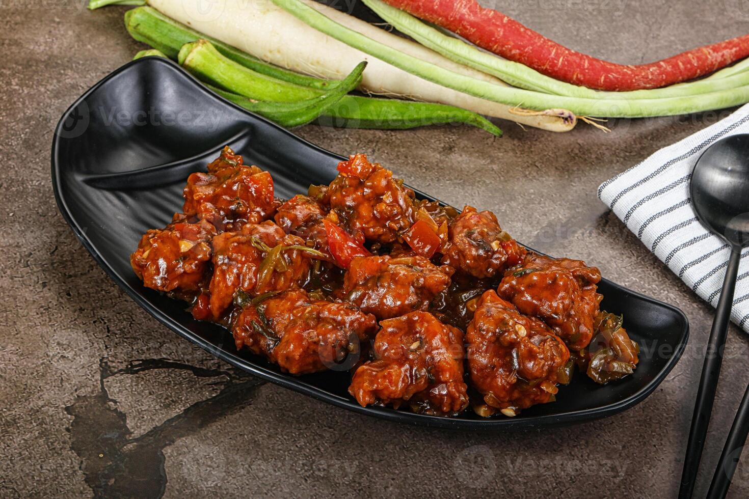 Manchurian chicken with sauce and spices photo
