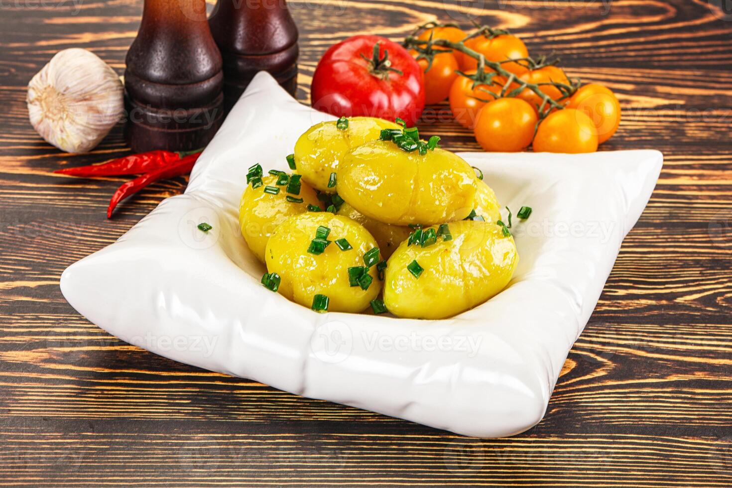 Boiled young potato with green onion photo