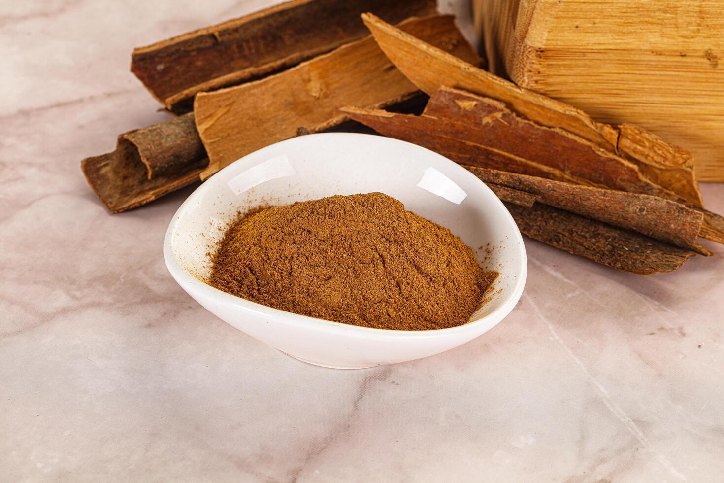 Natural Cinnamon powder with sticks photo