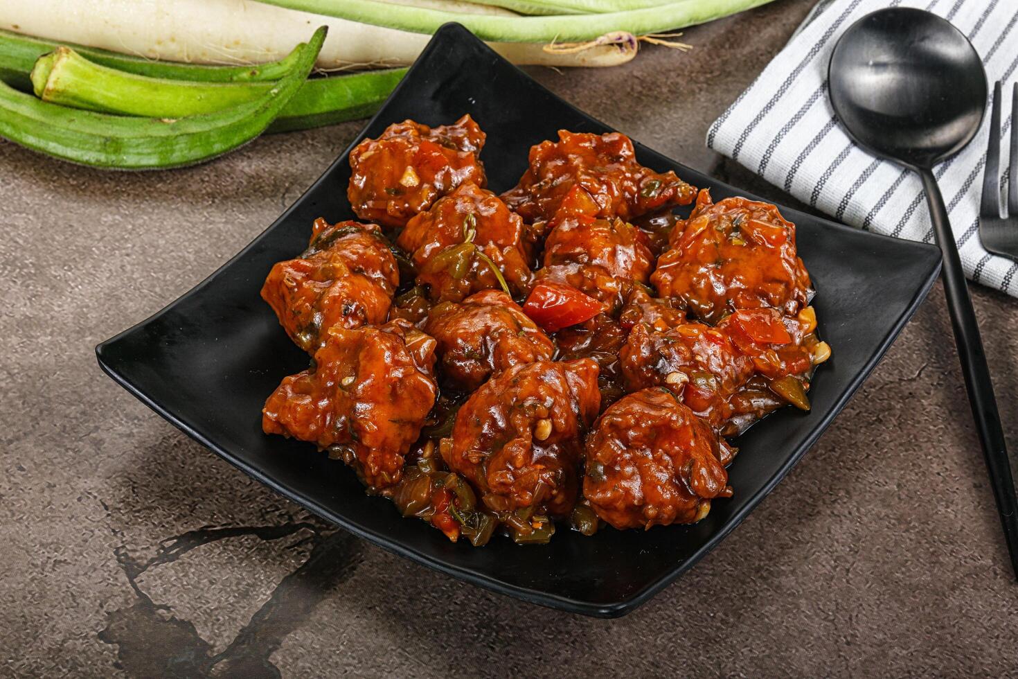 Manchurian chicken with sauce and spices photo