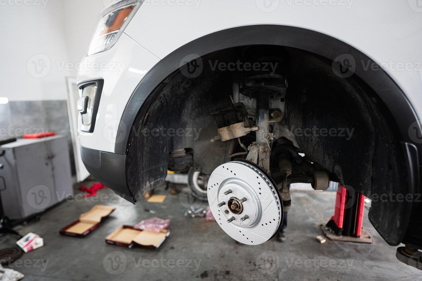 Car brake disc replacement in a professional auto repair shop photo