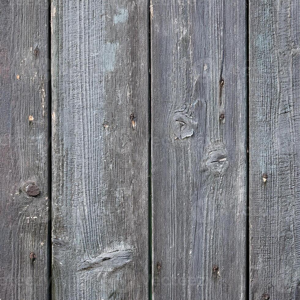 A close up of a wooden fence with some nails photo
