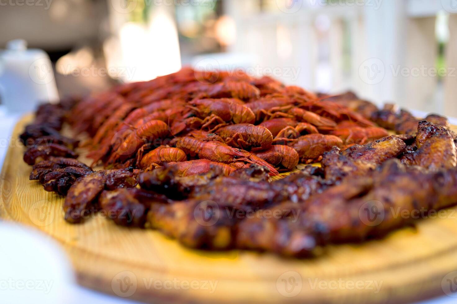 Fresh red boiled crawfish. Big plate of tasty boiled red crawfish close up on table. Crayfish to beer concept photo