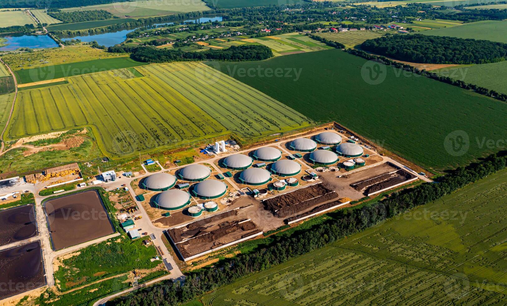 Distillation process is used to produce bio gas at station. Biogas station at the green field. View from above. Ecological production concept photo