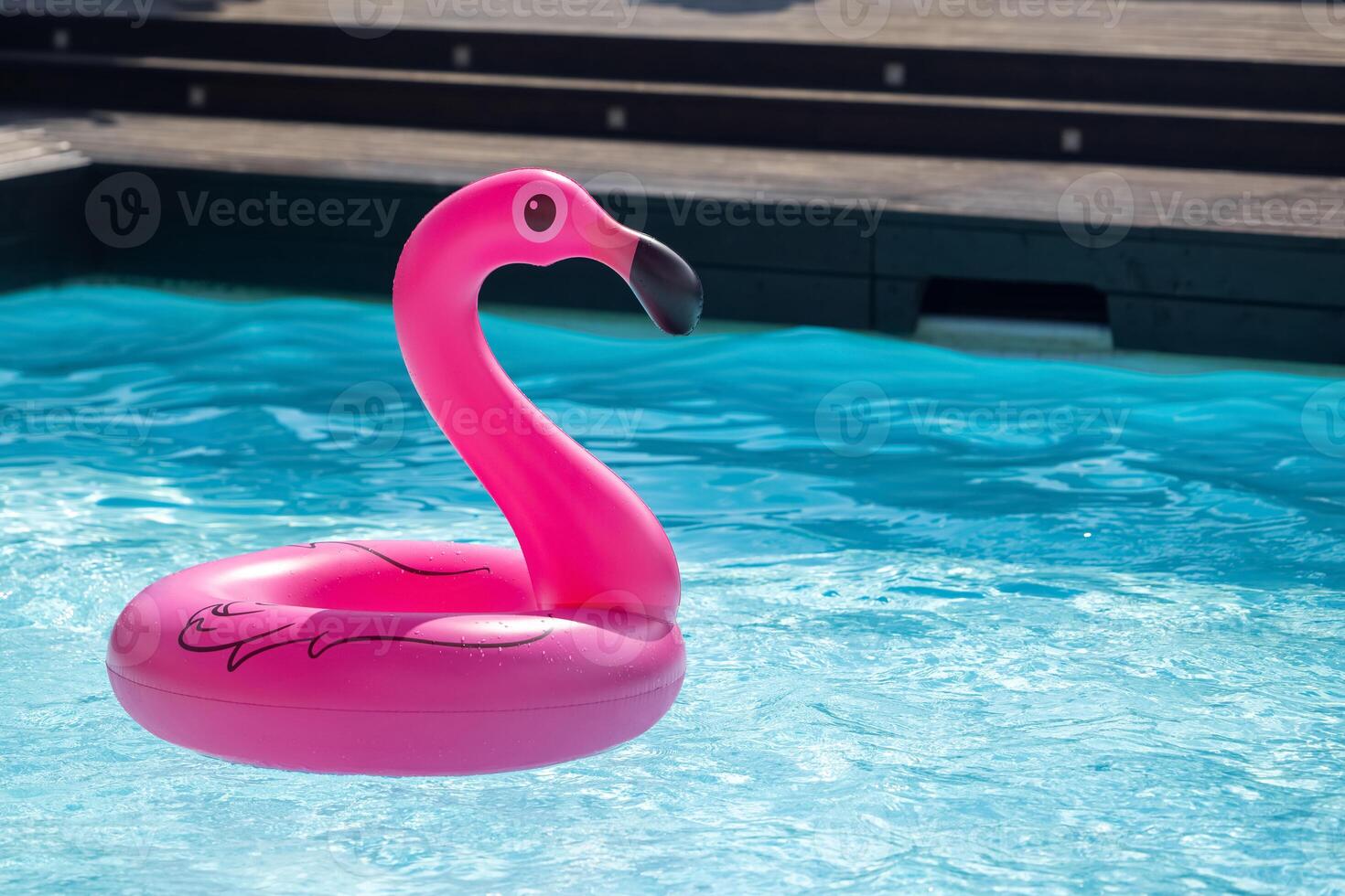 Vacation travel concept with inflatable pink flamingo float toy mattress photo