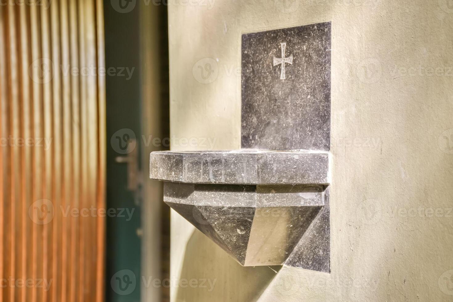 A small stone wall mounted on the side of a building photo