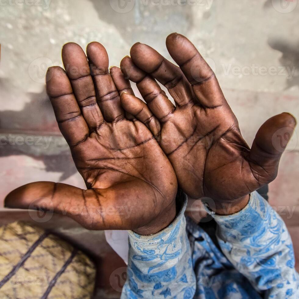 The calloused hands of a working man with dark skin tell a story of labor photo