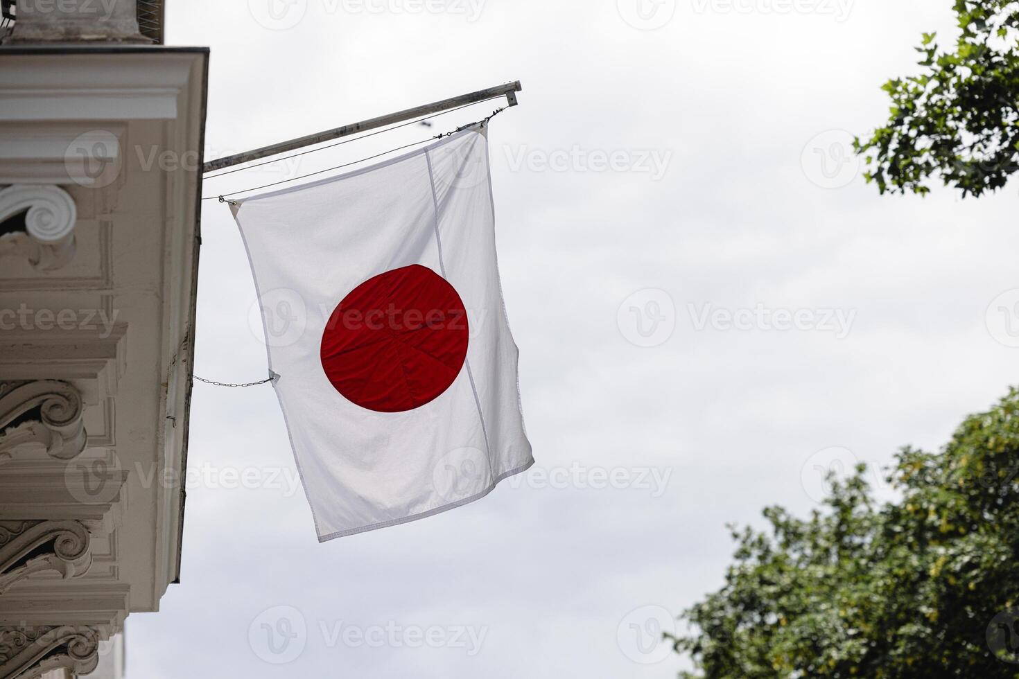 Japanese flag near a house in Europe close-up photo