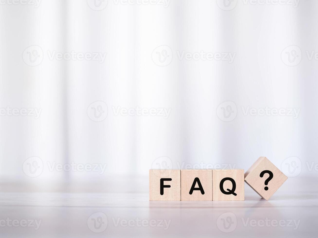 Wooden block with word the FAQ with question marks. The concept of question or answer time. photo