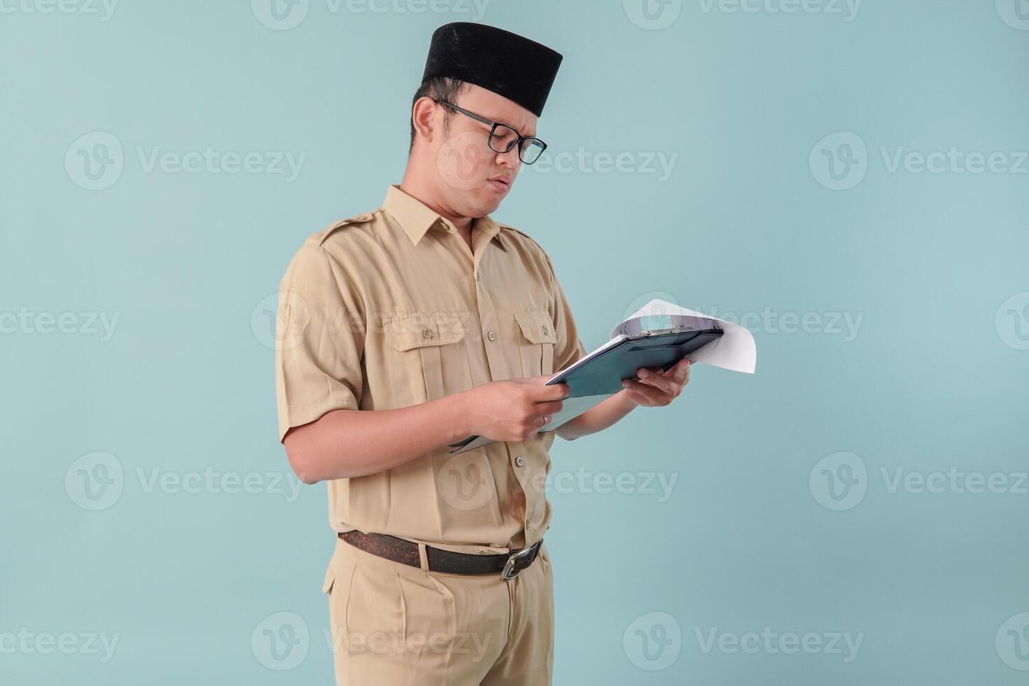 Young government worker man reading document paper or report with serious expression. photo