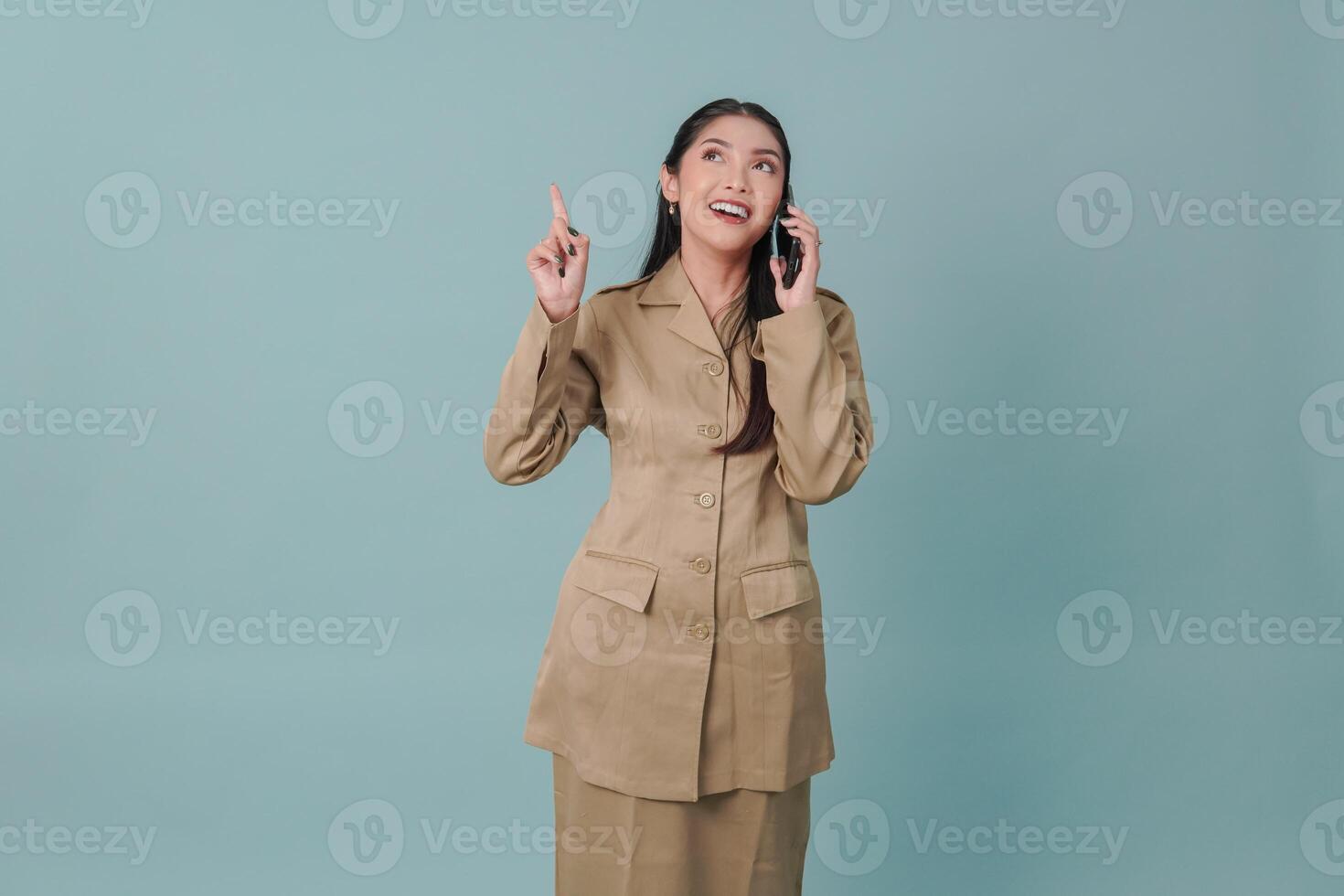 Happy government worker woman while talking on the phone and pointing to the copy space upward. photo