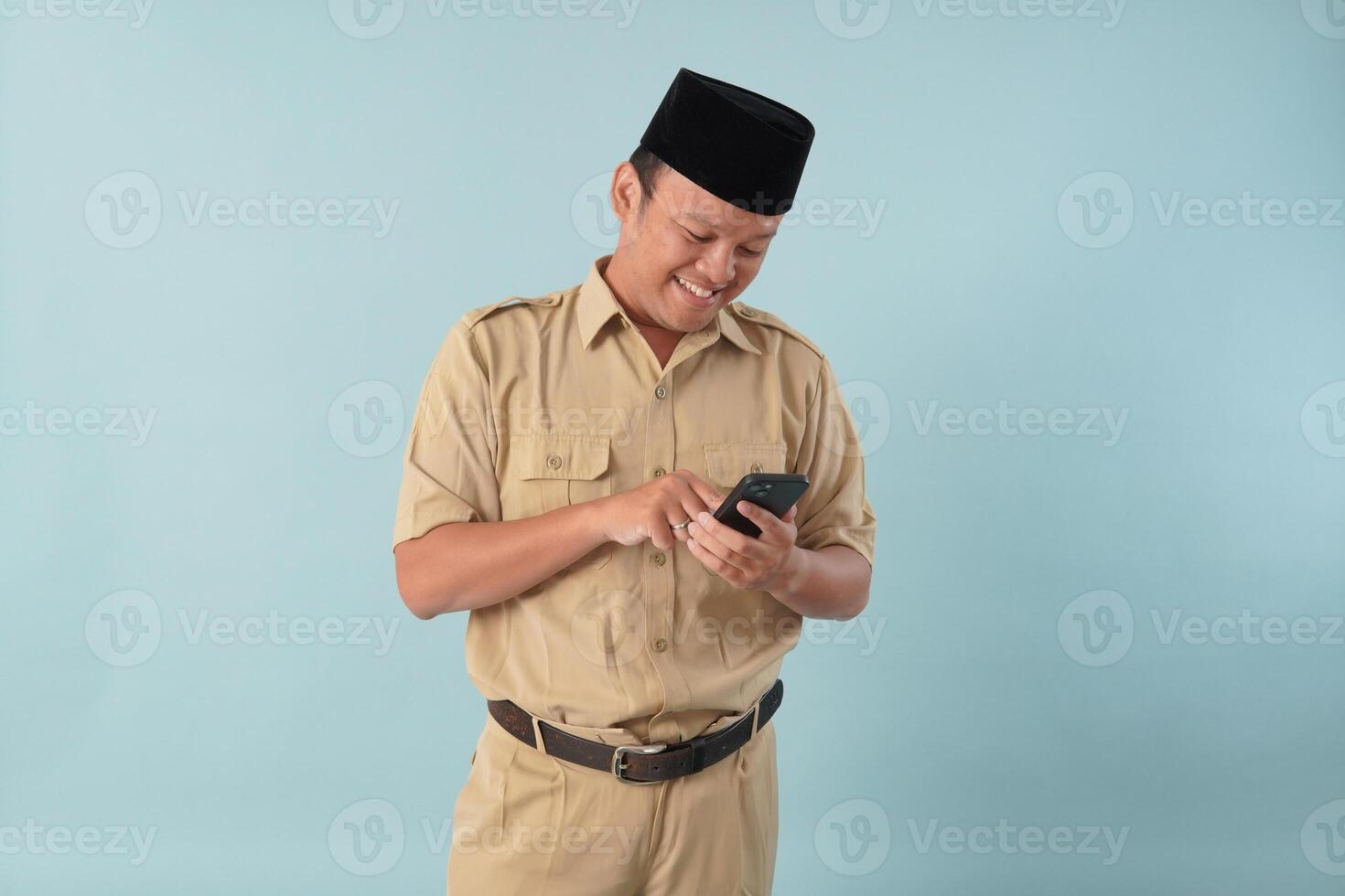 Cheerful government worker man wearing khaki uniform using smartphone to browse internet. photo