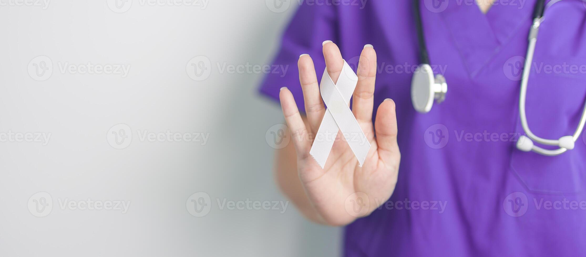 Stop Violence Against Women and November Lung Cancer Awareness month. Doctor with White ribbon in hospital. Healthcare and World Cancer day concept photo