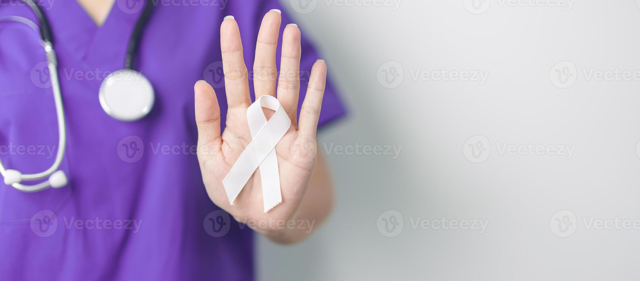 Stop Violence Against Women and November Lung Cancer Awareness month. Doctor with White ribbon in hospital. Healthcare and World Cancer day concept photo