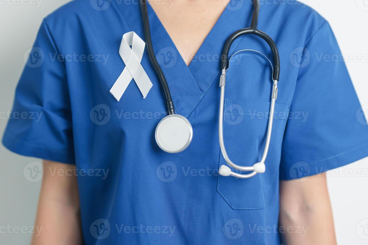 November Lung Cancer Awareness month and Stop Violence Against Women. Doctor with White ribbon in hospital. Healthcare and World Cancer day concept photo