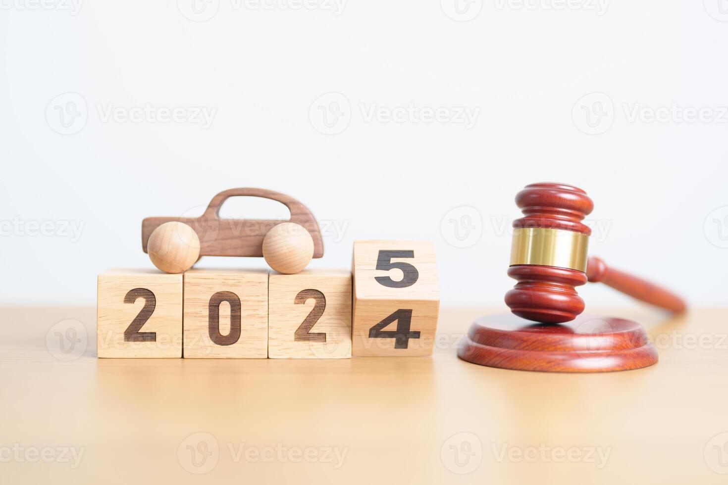 2024 end year to Happy New Year 2025 with small toy car models and Judges gavel on desk in courthouse. Car Law, Insurance, auto Tax, Auction and Bidding concepts photo
