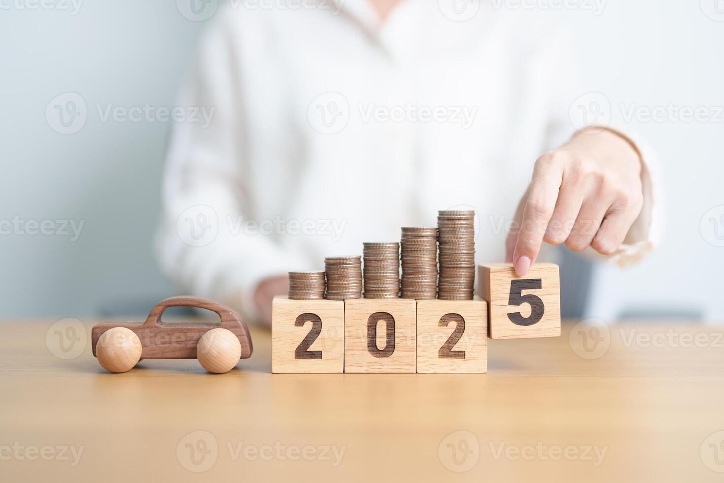 Happy New Year 2025 with car model and Coins Money stack for deposit and Automobile Tax. Money Saving, Car Insurance, Financial, vehicle Repair and Maintenance and New Year concept photo