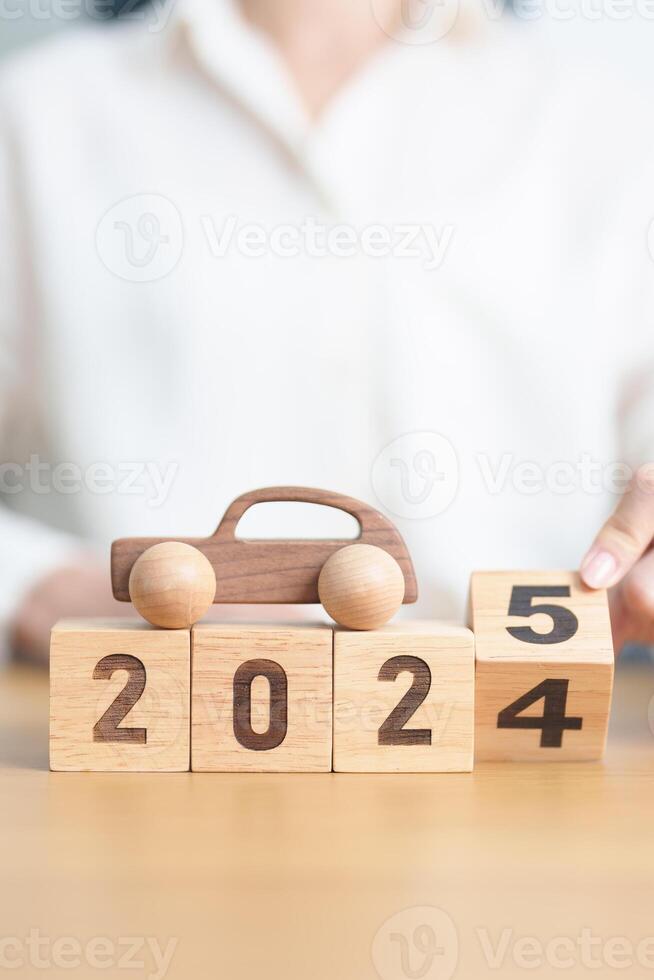 2024 end year to Happy New Year 2025 with Car model on table. Automobile Tax, Car Insurance, Financial, vehicle Repair and Maintenance and New Year concept photo