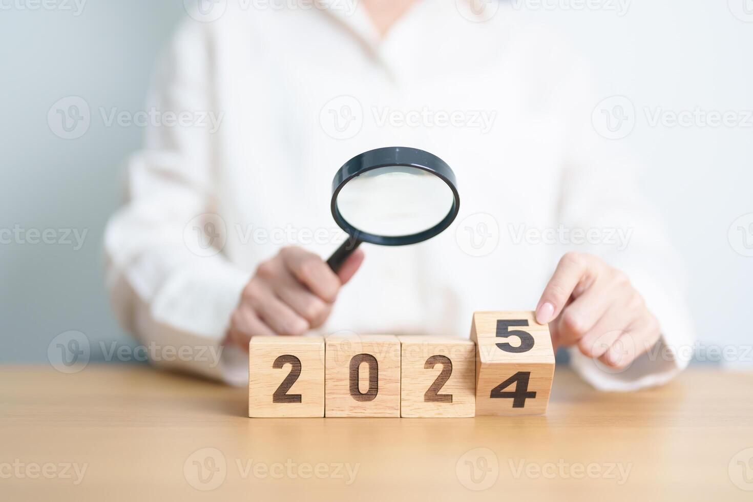 2024 end year to Happy New Year 2025 with magnifying glass and people. hiring, employee, recruitment, job, SEO and jobless concept photo