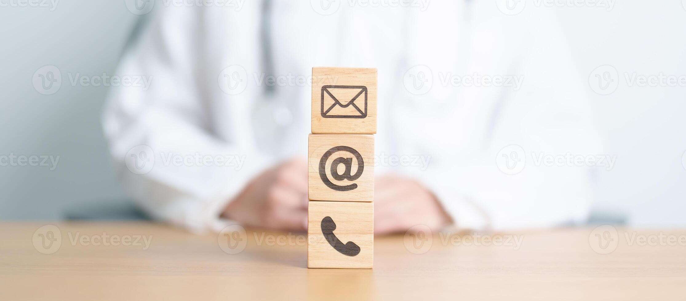 Contact Us concepts. Wood block of Email, call Phone and Website Address sign against Doctor background. Healthcare Customer support hotline, business Marketing, health, communication and Advertising photo