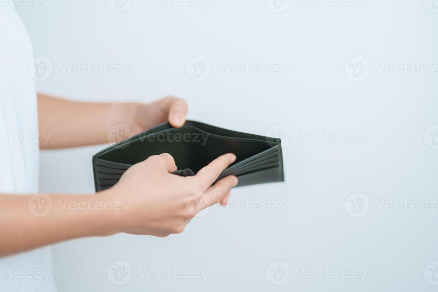 Woman hand holding and open empty wallet with not have banknote money. Crisis, loan, bankrupt and debt financial concept. photo