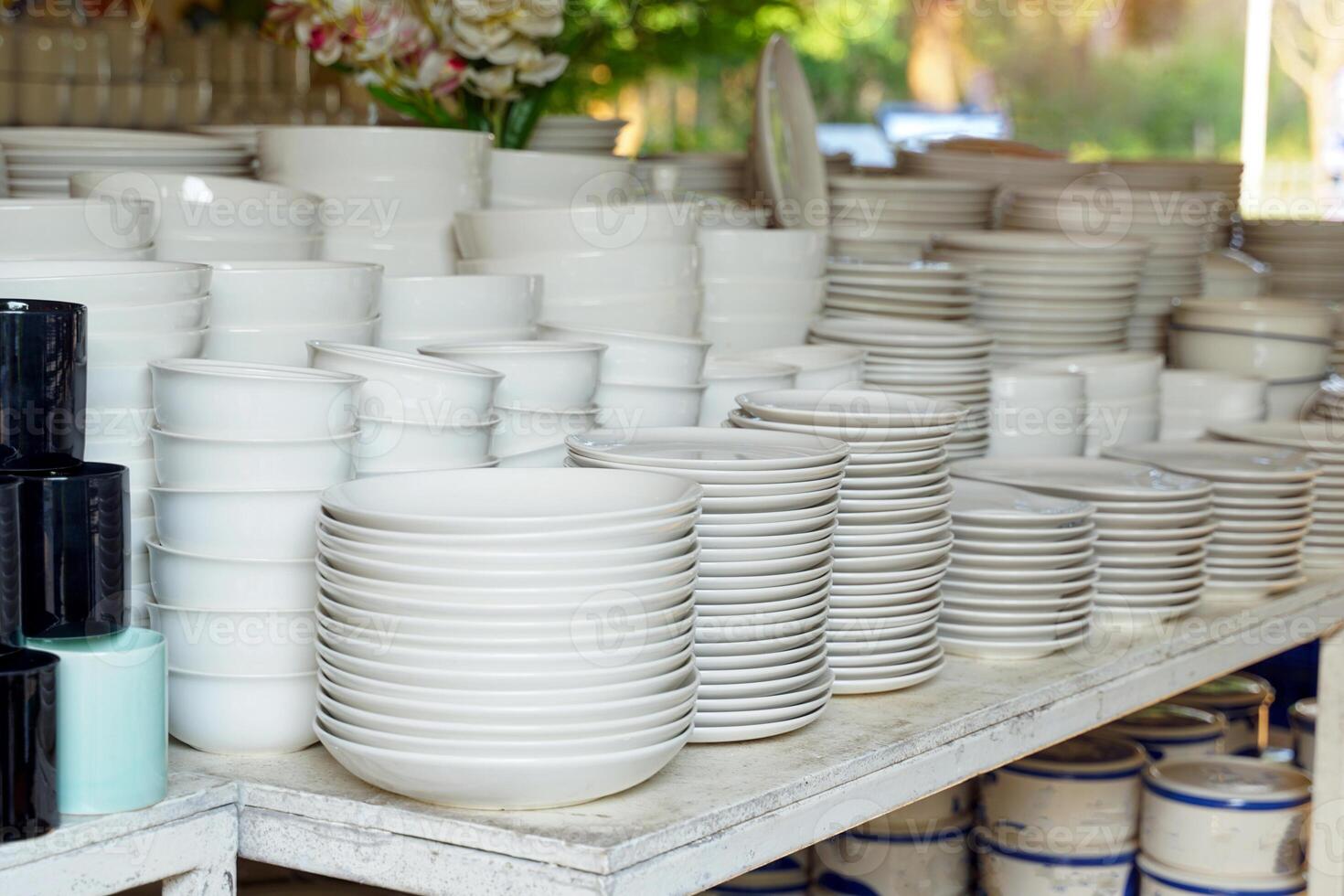 White ceramic cups, plates, bowls and crockery sets are sold at a discounted price at the store. photo