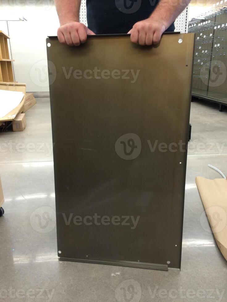 Person Holding Store Fixture Panel, Retail Store Set Up photo