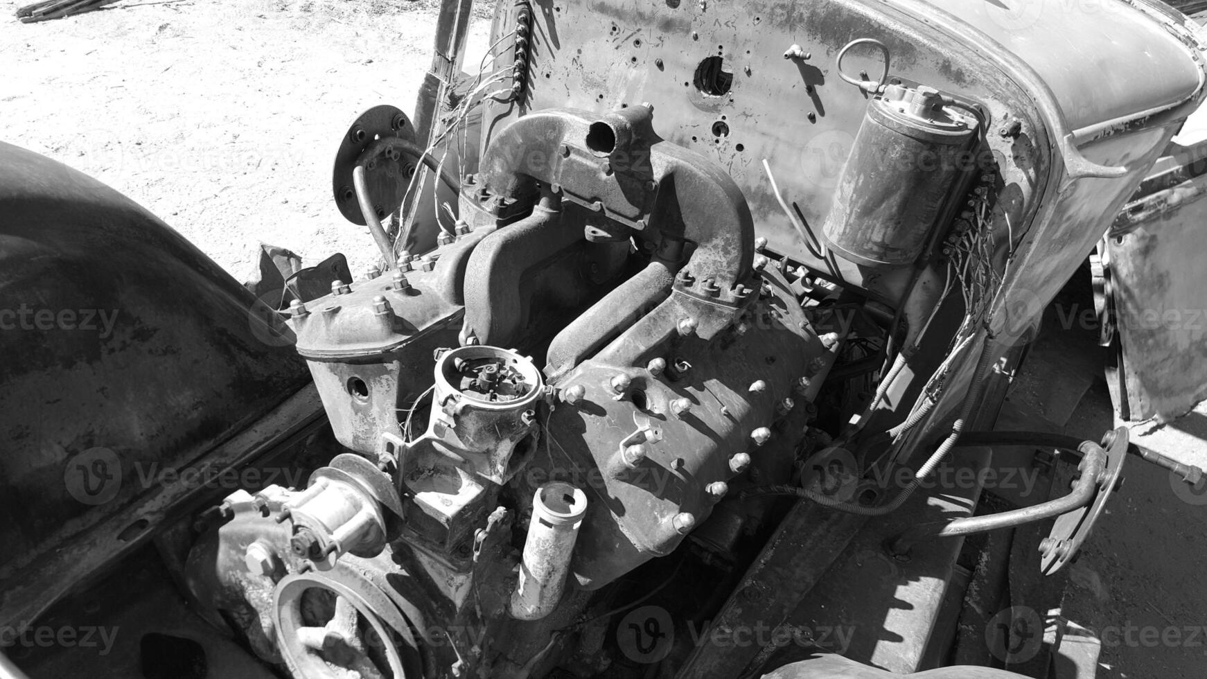 Black and White Engine Compartment of Old Vehicle Rusting in California Desert photo