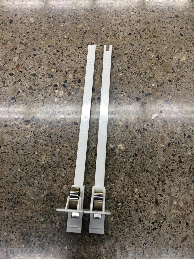 Parts of a Plastic Shelf Pusher System for Retail Merchandising photo