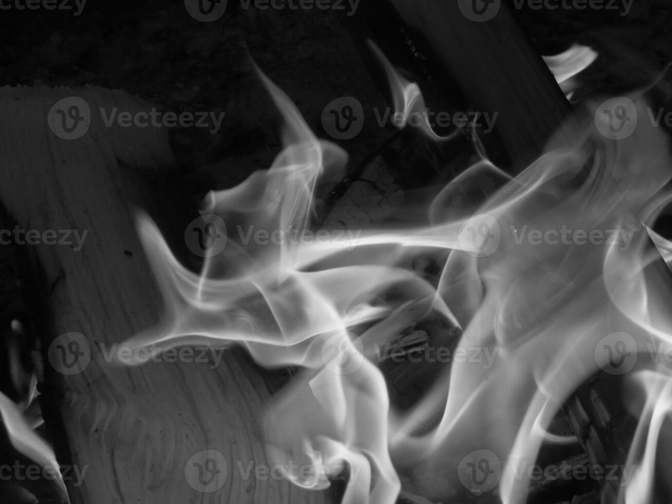 Black and White Close Up of Flames Bright Burning Fire in Campsite Fire PIt photo