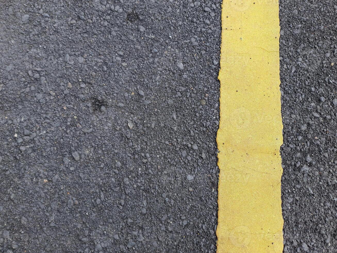 Asphalt road texture with yellow dividing line. abstract background and copy space concept photo