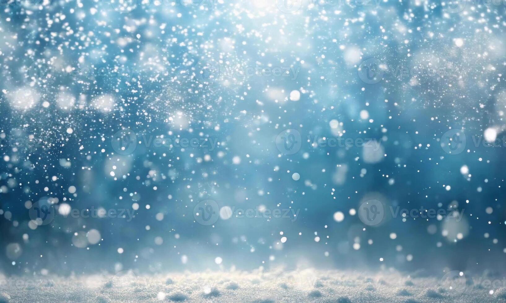 Light snow falls from top to bottom on an abstract blue background photo