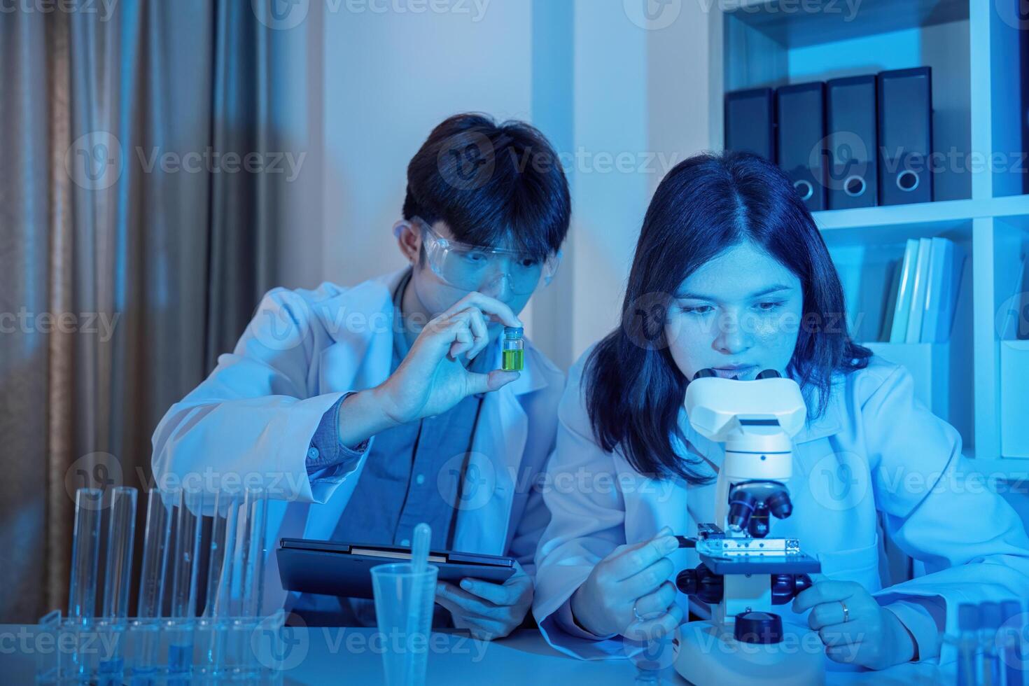 Scientists Conducting Experiments in a Modern Laboratory Setting with Advanced Equipment and Technology photo
