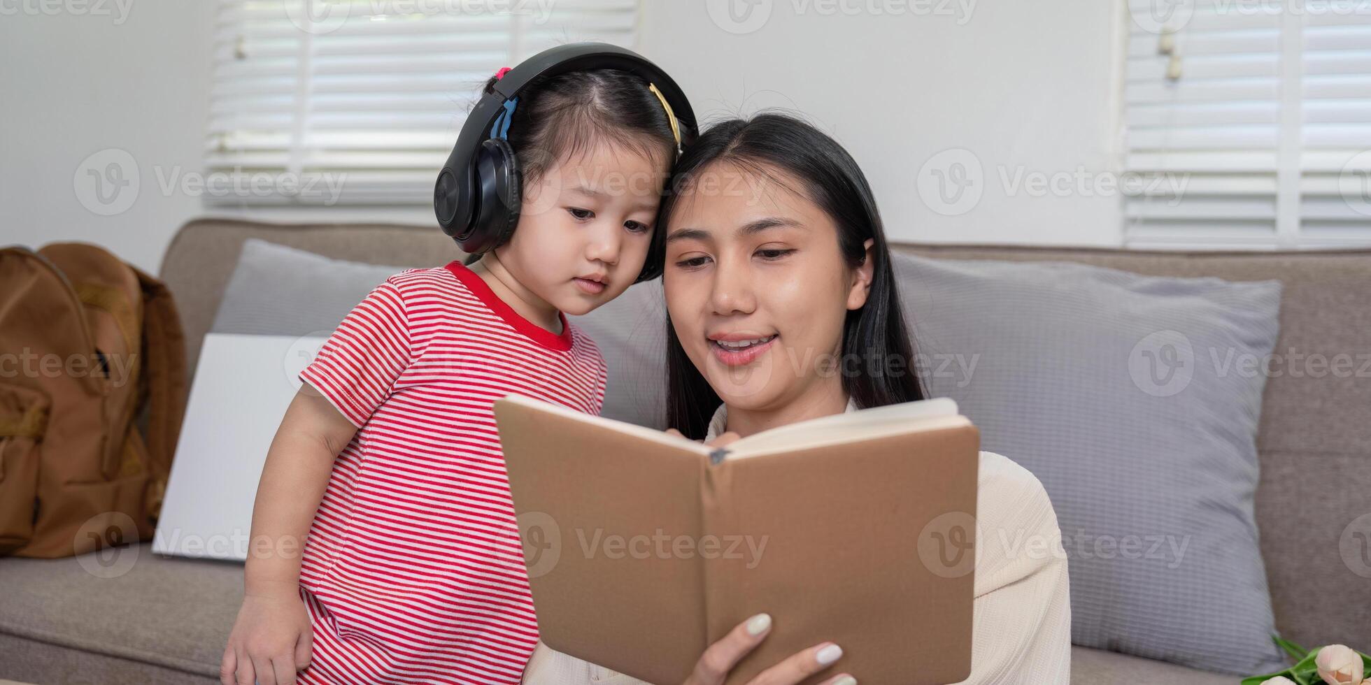 Engaged Mother and Daughter Sharing a Story from a Book photo