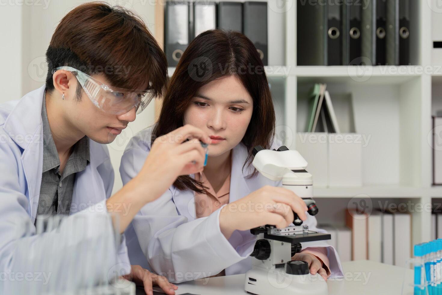 Science Researchers Conducting Microscope Experiments - Concept of Collaborative Scientific Exploration photo
