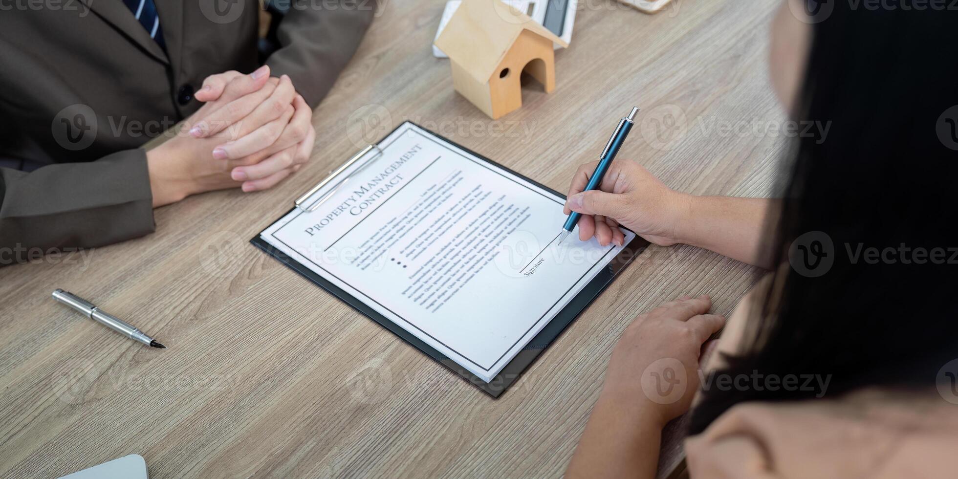 Real Estate Agent Guiding Client Through Property Management Contract Discussion photo