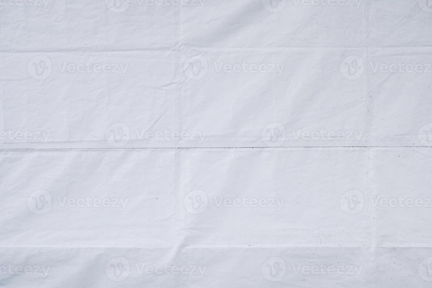 White tarpaulin with folds and creases as background texture photo
