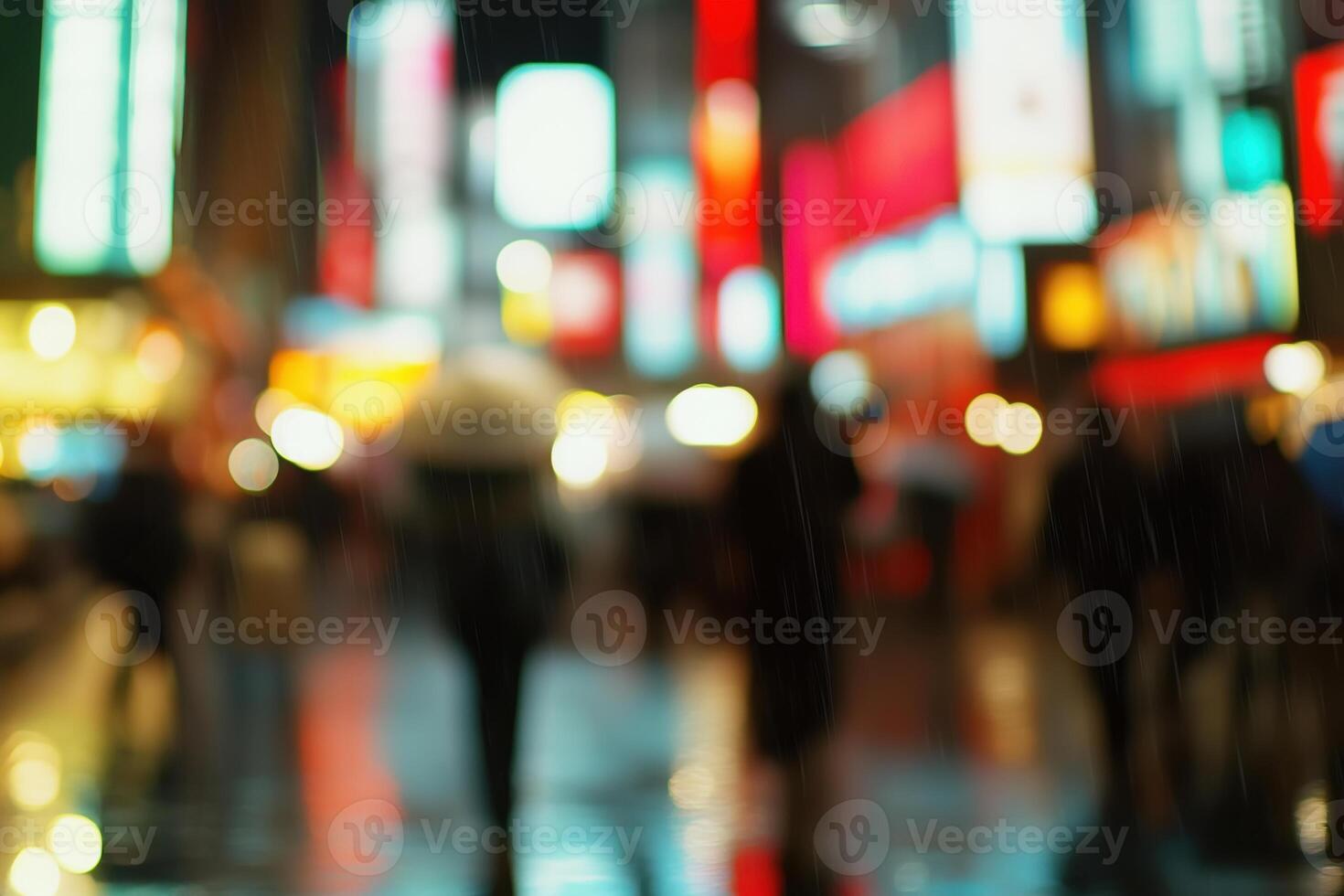 defocused background image of people walking in the rain on city street with neon lights at night photo