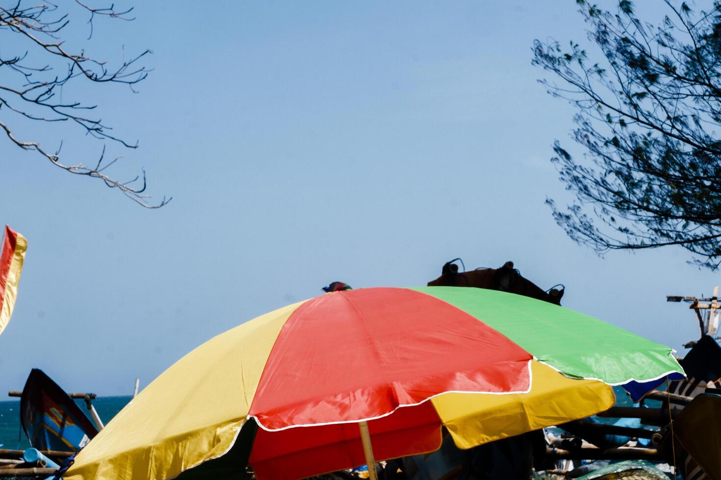 a colorful umbrella on the beach photo