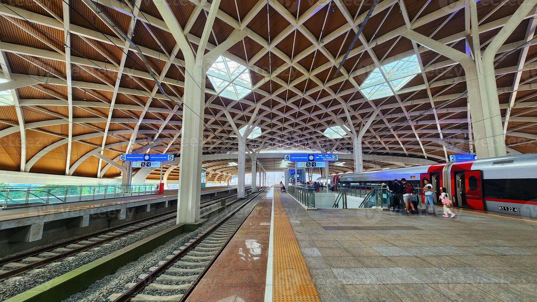 a train station with a large roof and a train photo