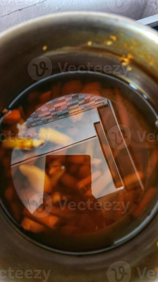 a pan filled with liquid and vegetables photo