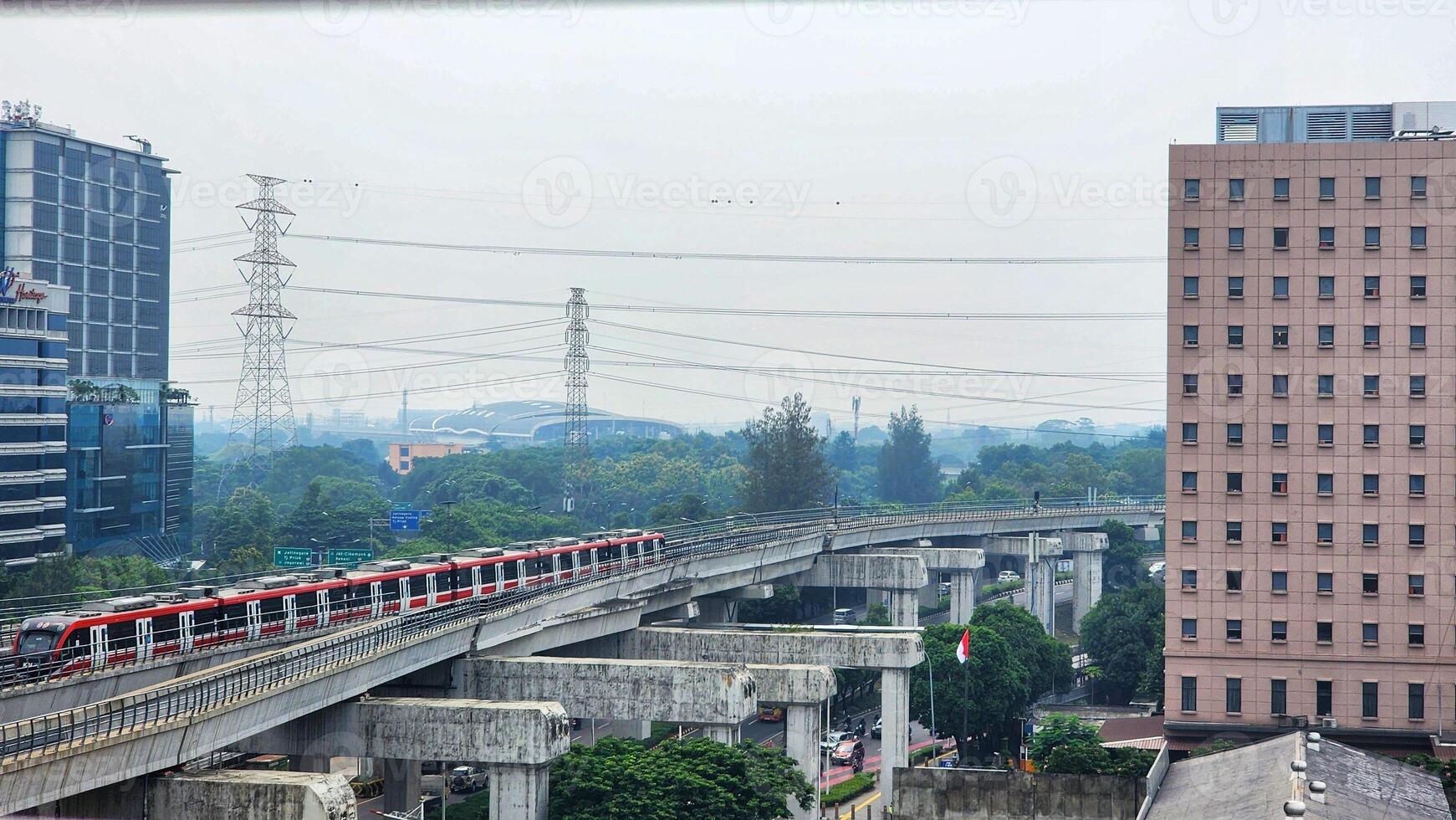 a train traveling on a bridge over a city photo