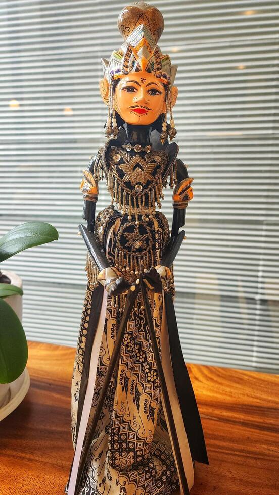 Wayang golek is a three-dimensional performing art made from wood that is carved to resemble humans, then dressed up with cloth as clothing to make it more attractive. photo