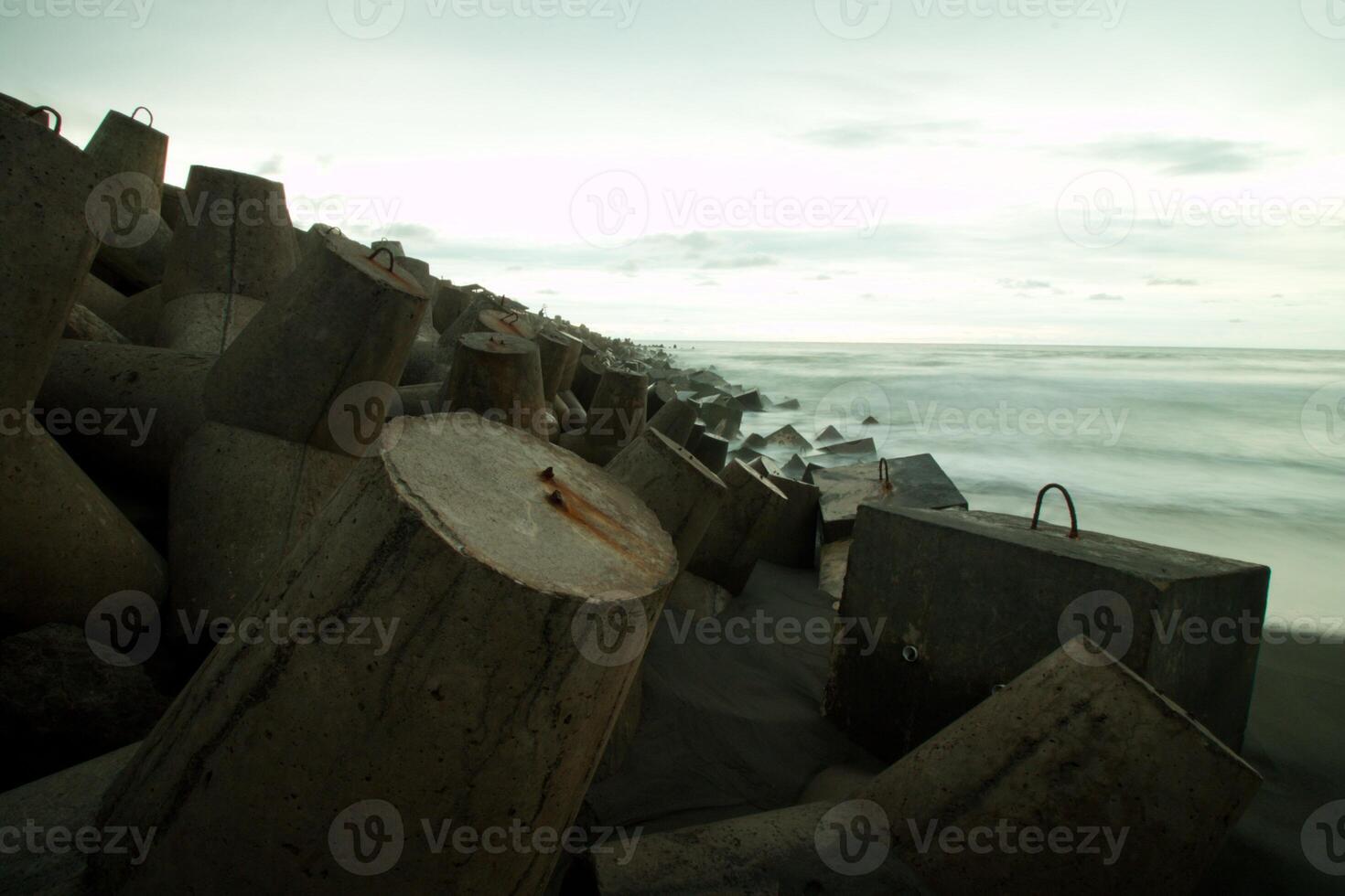 a pile of concrete blocks on the beach photo