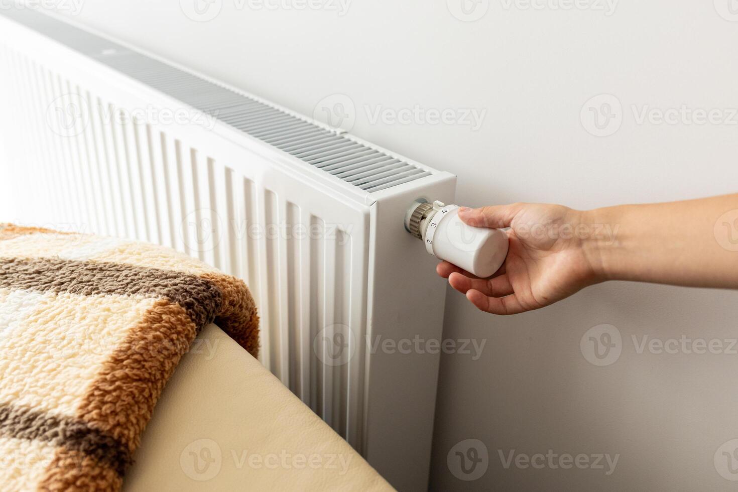 modern radiator for heating in the apartment with power regulators. ideal for those costs of heating and utilities in winter, person a person regulates the level of heat photo