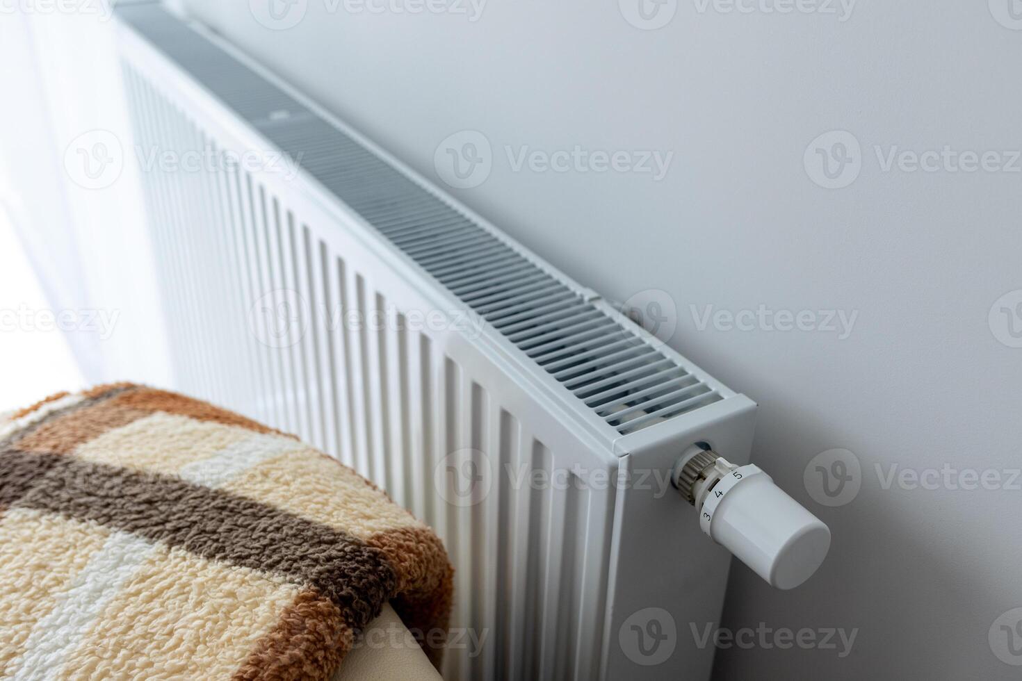 modern radiator for heating in the apartment with power regulators. ideal for those costs of heating and utilities in winter, warmth and comfort in the apartment photo