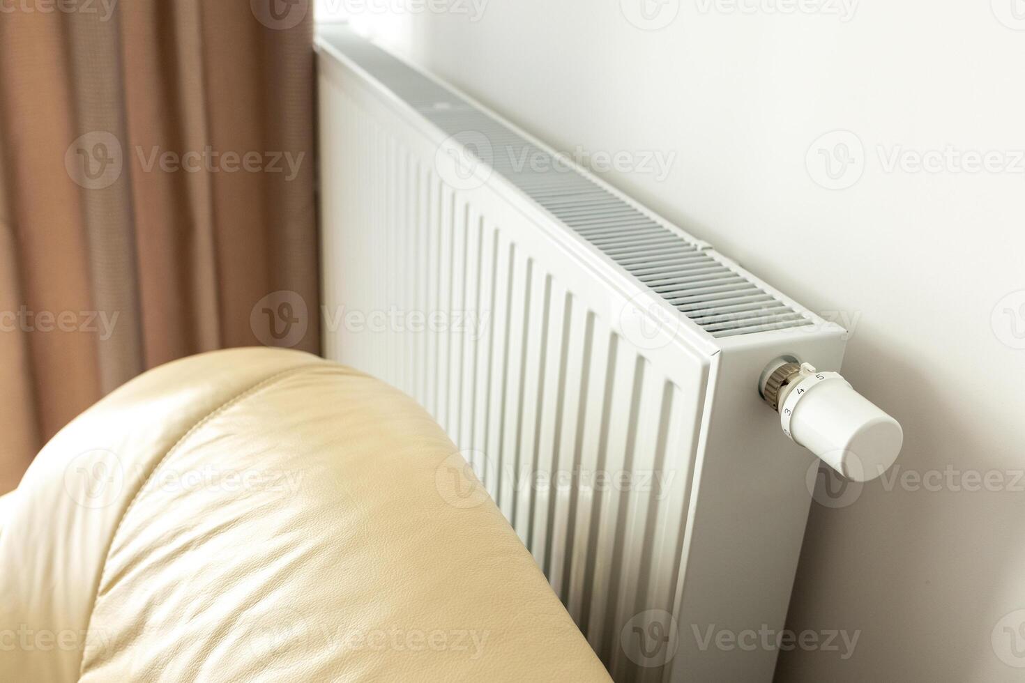 modern radiator for heating in the apartment with power regulators. ideal for those costs of heating and utilities in winter, warmth and comfort in the apartment photo